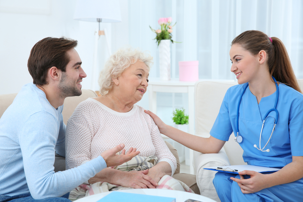 Nurse,Talking,With,Grandmother,And,Her,Grandson,Indoors